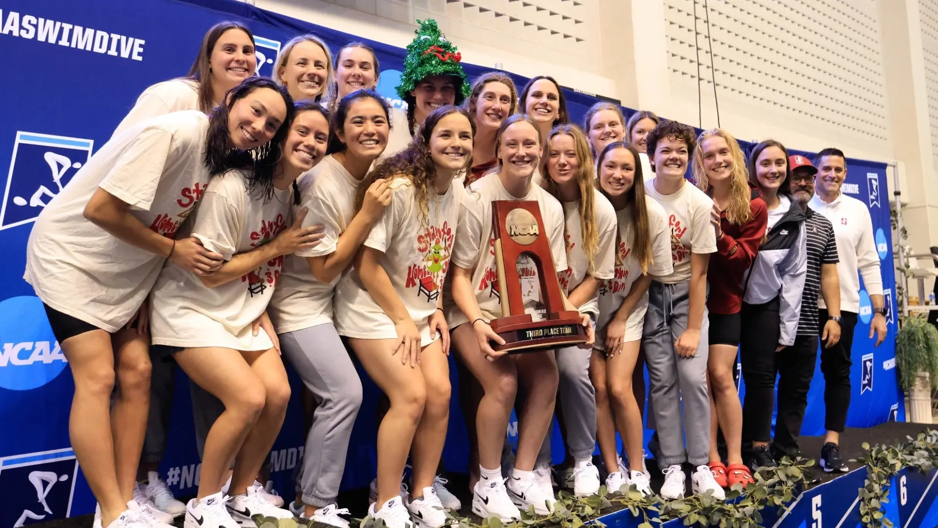 Stanford women's swimming team celebrating with the NCAA third-place trophy